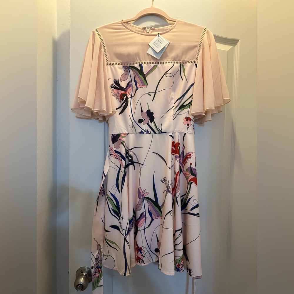 Beautiful pink flower dress, never worn and it still has its original tags.